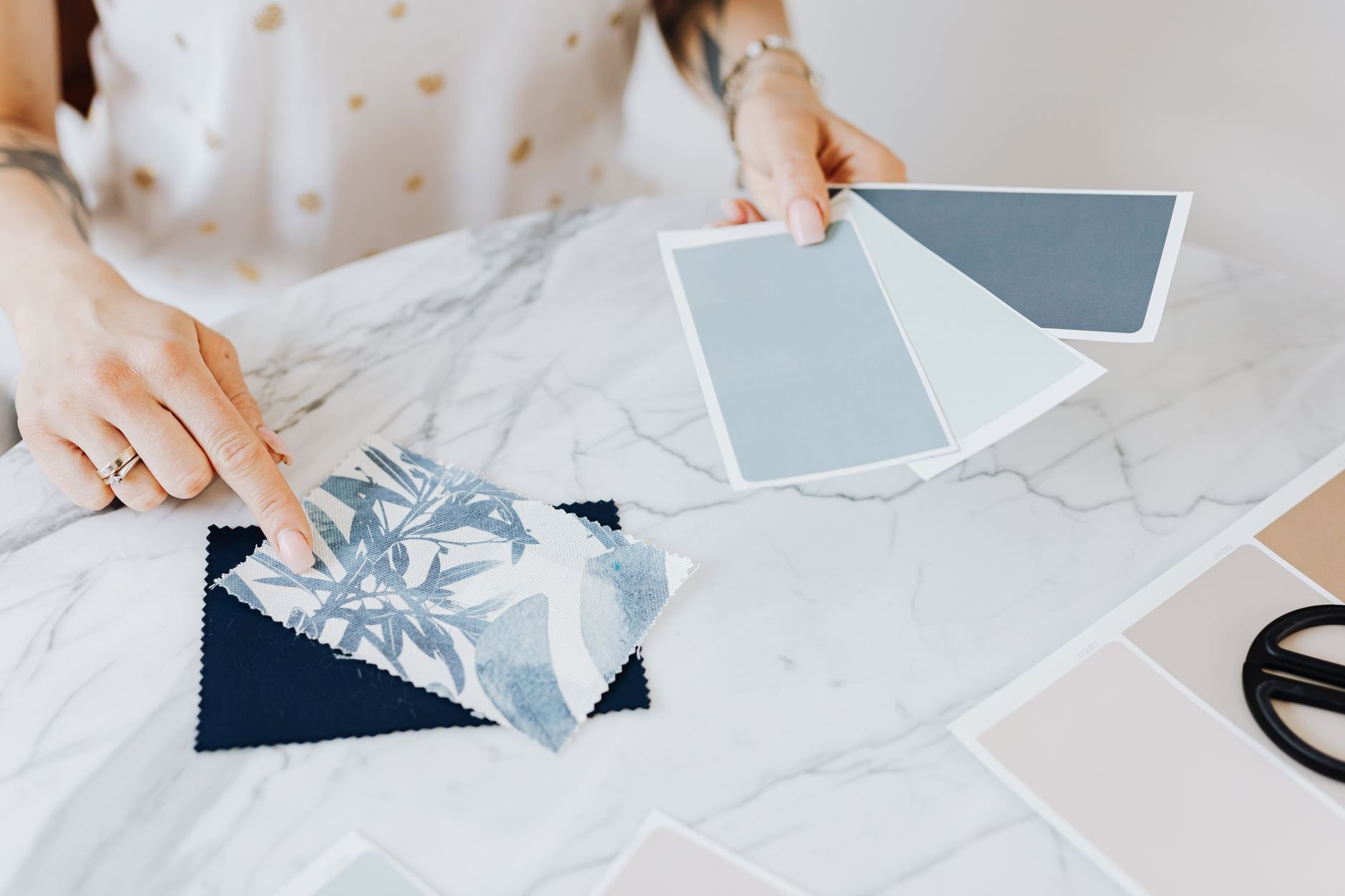 Woman selecting color and fabric swatches for a design project.
